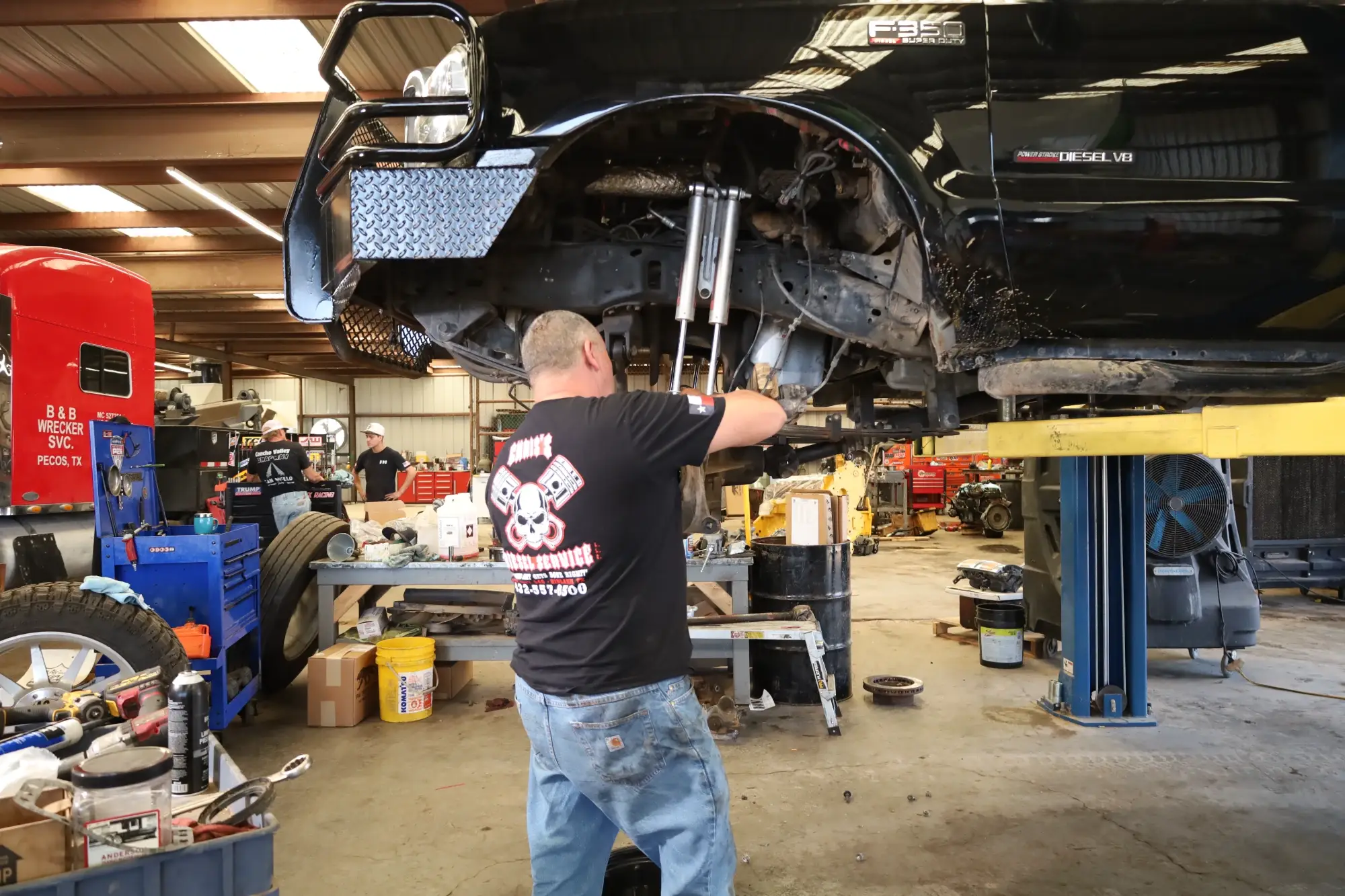Technicians performing diesel & gas truck repairs in Midlnd TX workshop with engine diagnostics & maintenance