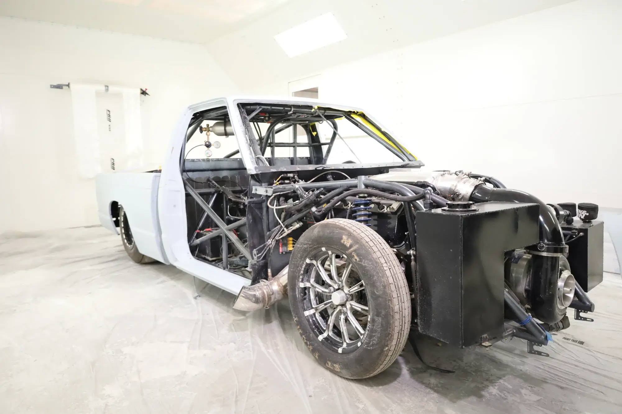  Professional collision shop showing race truck stripped for paint, bodywork, and panel repair