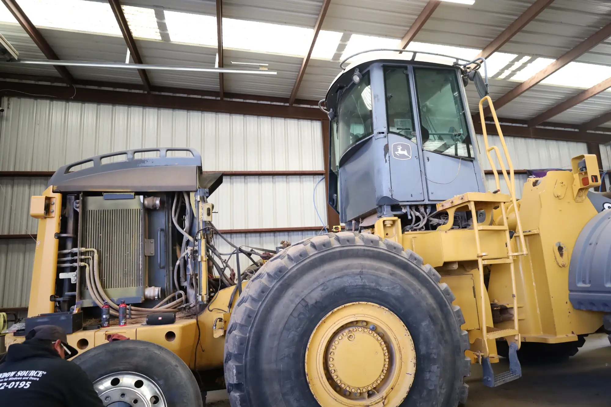 Heavy Yellow bulldozer undergoing inspection and maintenance in a professional workshop