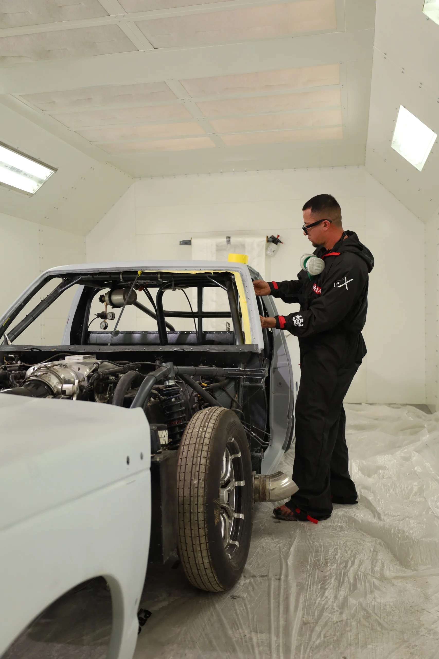 Technician preparing a vehicle body for collision repair and paint work at Chris’s Diesel Service in Midland, TX