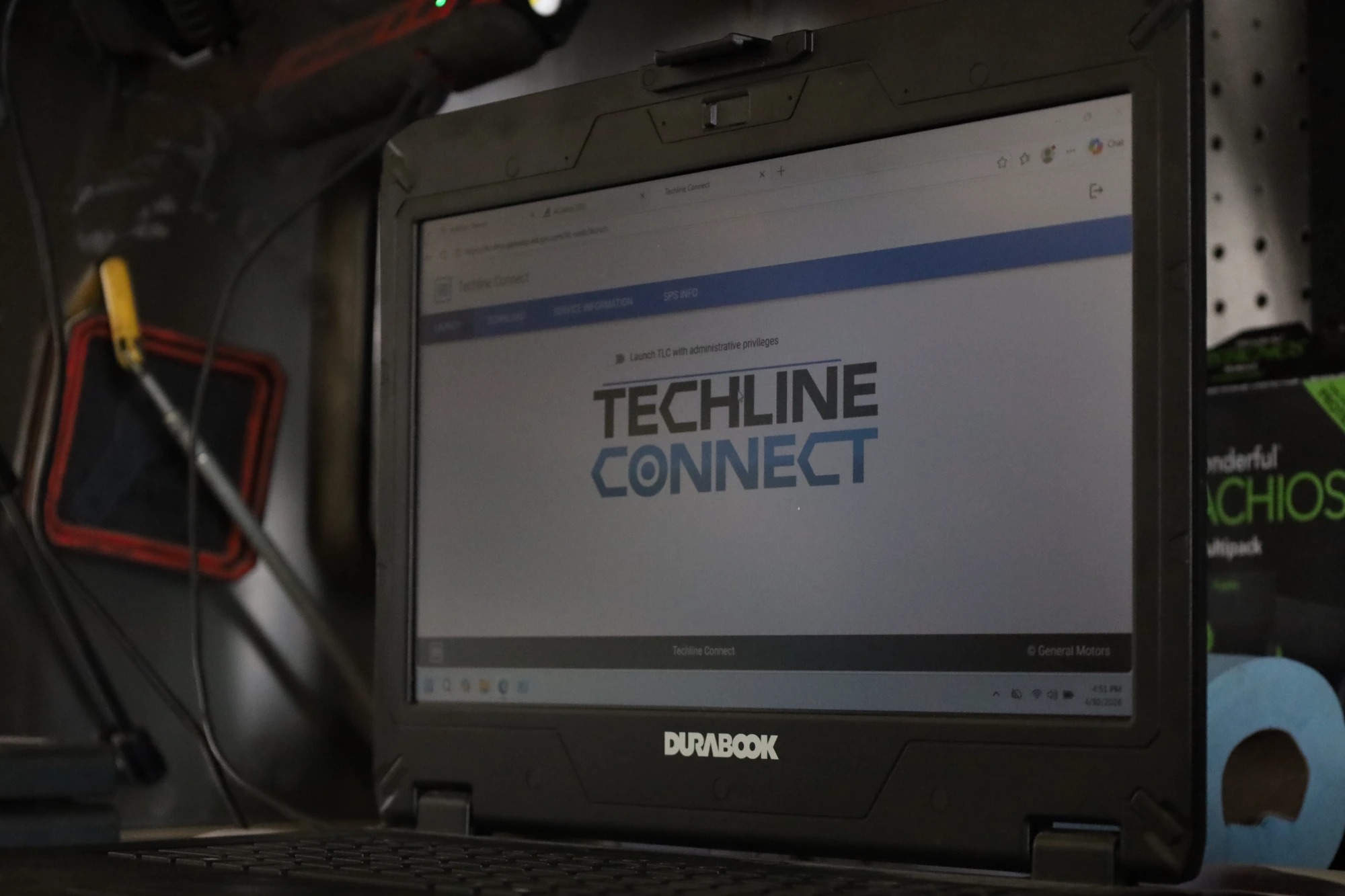 A rugged Durabook laptop running General Motors Techline Connect and SPS diagnostic software, used for performing professional full vehicle diagnostics by Chris's Diesel Service in Midland TX