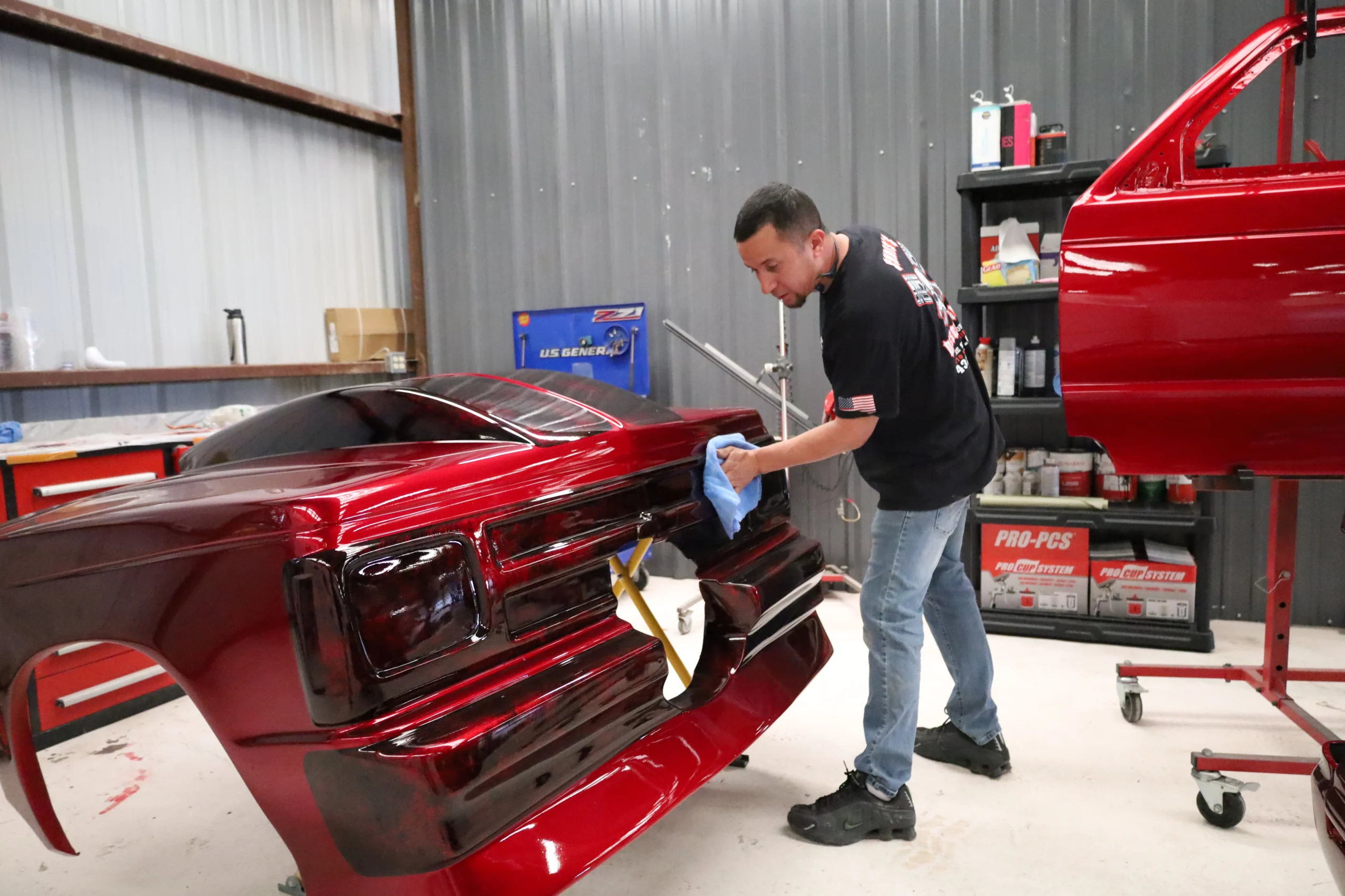 Technician inspecting a freshly painted vehicle panel during paint matching and re-spray service at Chris’s Diesel Service in Midland, TX