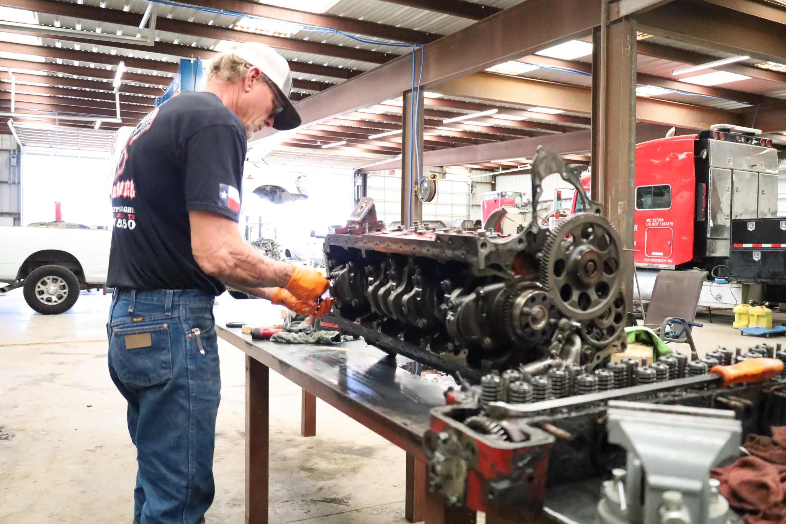 Technician rebuilding diesel engine block at Chris's Diesel Service in Midland TX