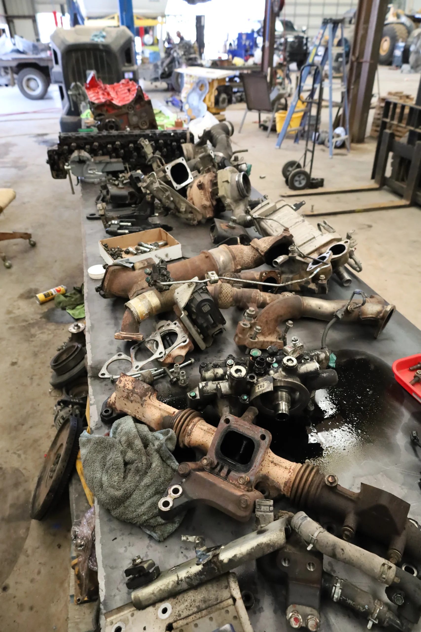 Diesel fuel system components and injectors laid out for service at Chris's Diesel Service Midland TX