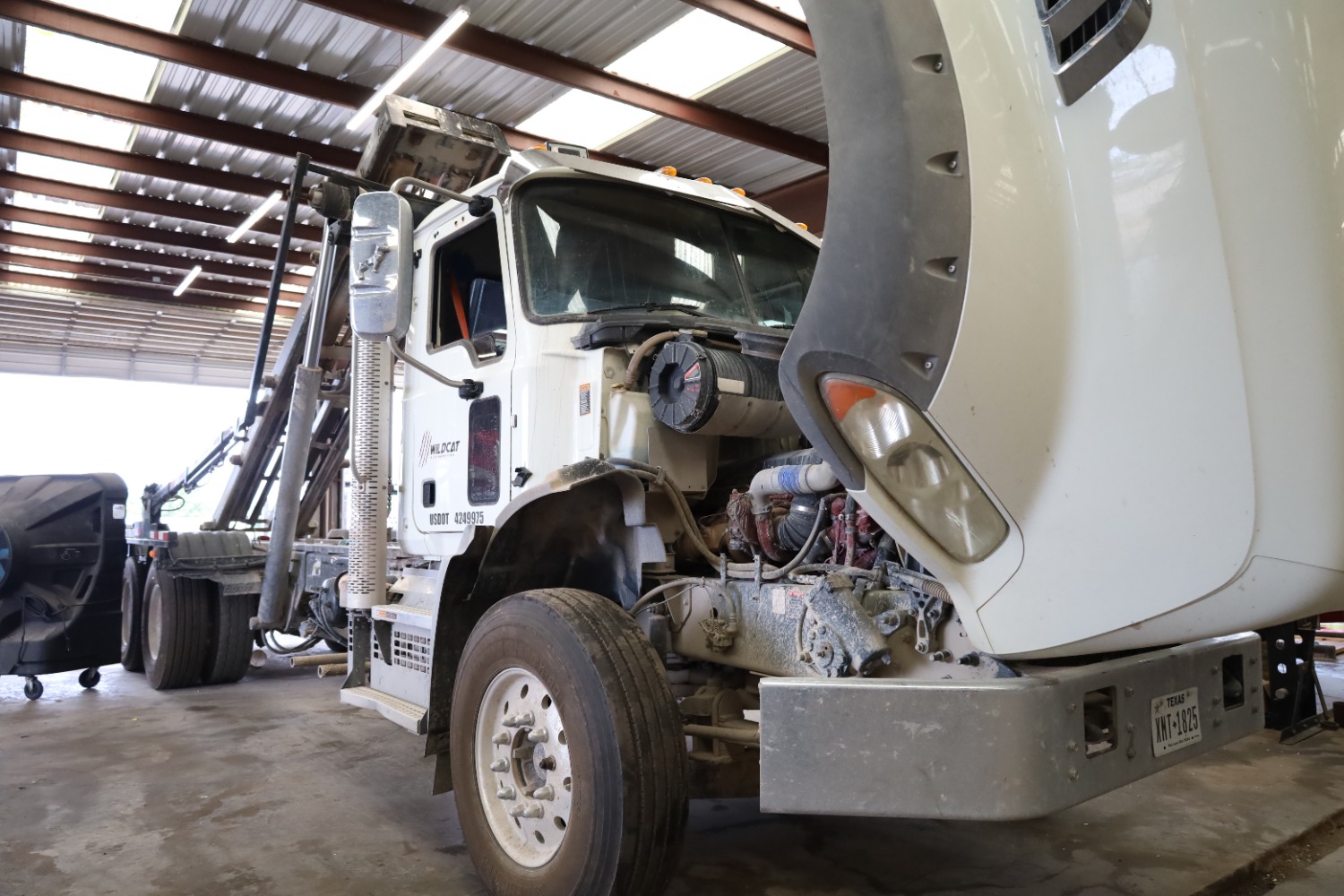 Turbocharger and charge air piping exposed on a diesel truck at Chris's Diesel Service in Midland, Texas