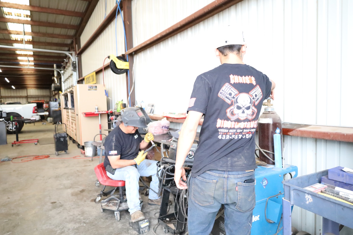 Technicians working at the in-house welding station at Chris's Diesel Service in Midland, Texas