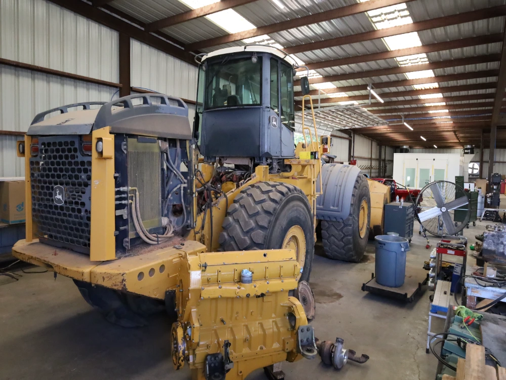 Telehandler with telescopic boom lifting materials on a construction site at Midland Tx.